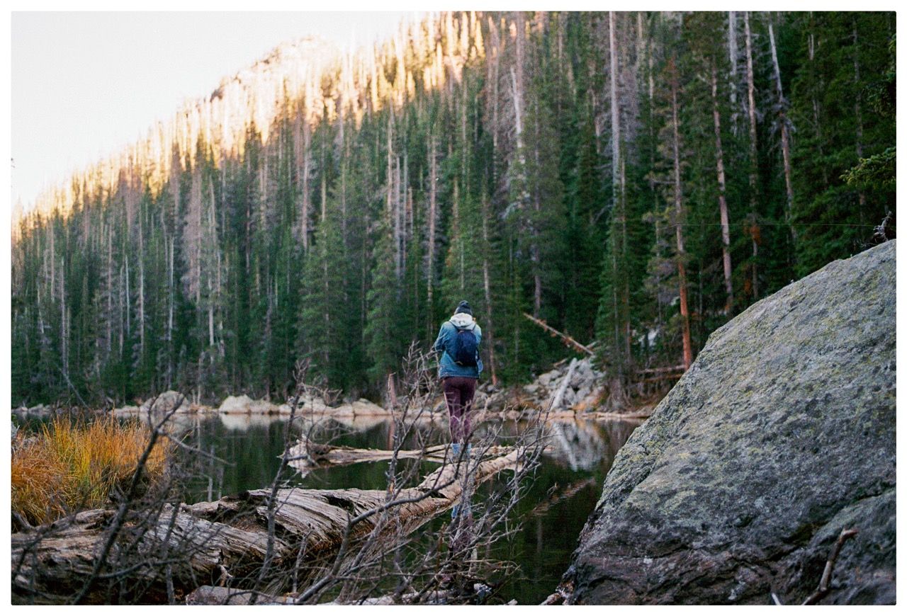 Person walking along a log on the water