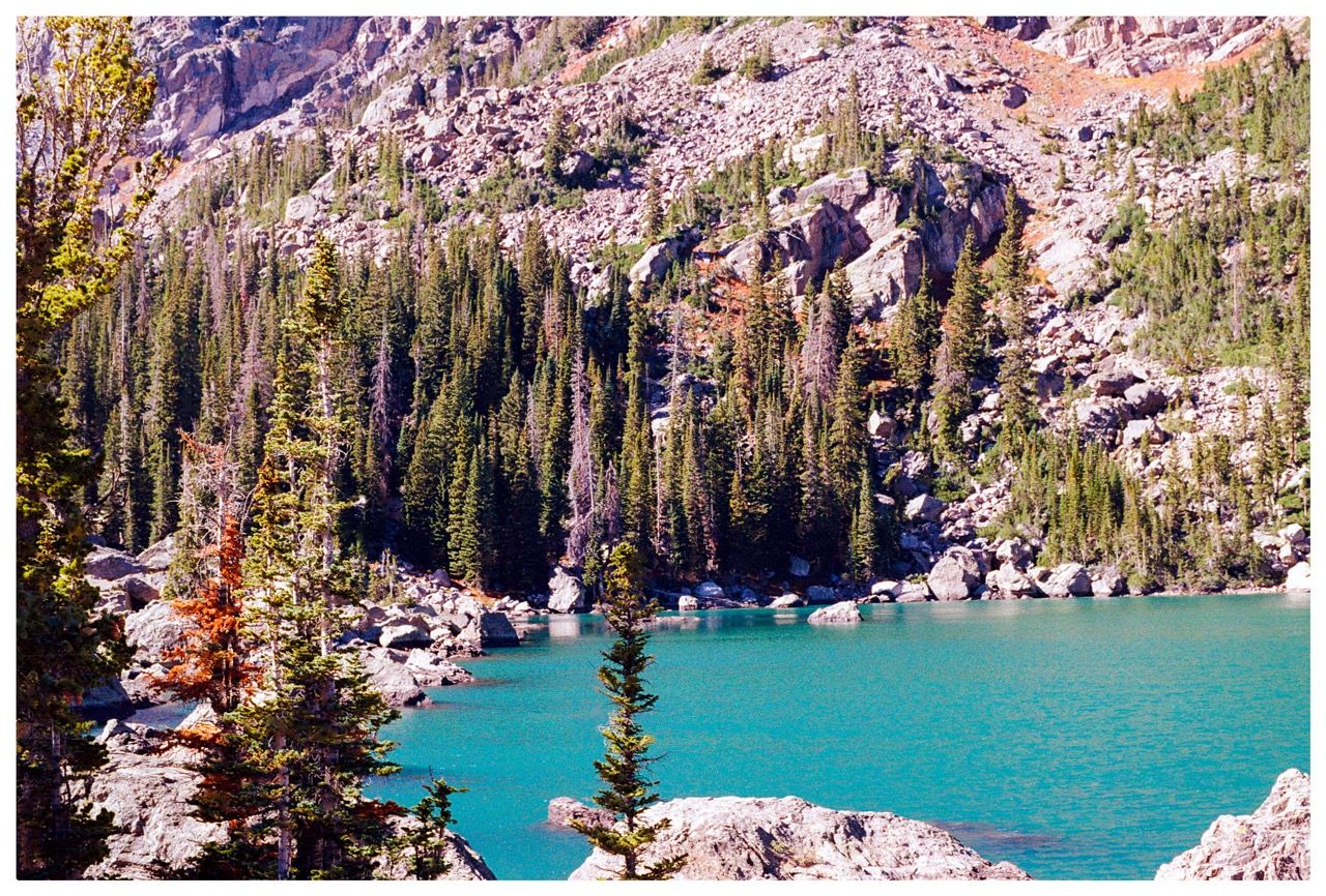 A blue lake with mountains in the background