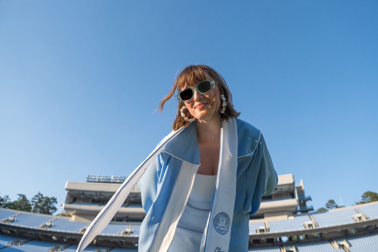 A grad in Kenan Stadium looking down into the camera